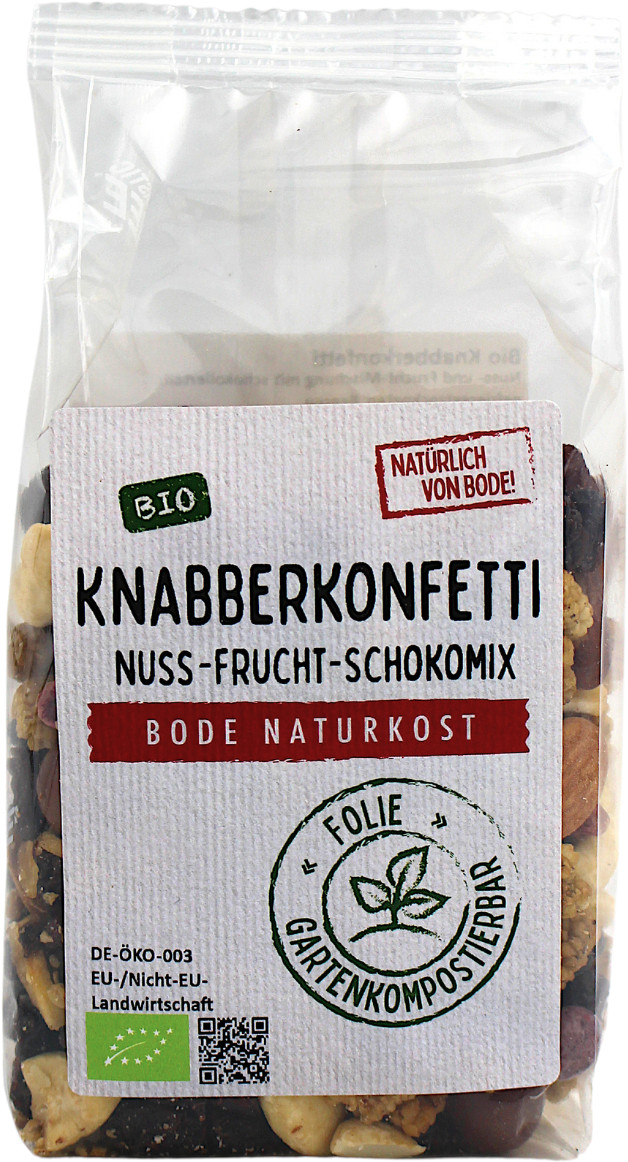 Packung Knabberkonfetti Nuss‑Frucht‑Schokomix von Bode Naturkost, transparenter Plastikbeutel mit weißem Etikett, Bio-Siegel und sichtbarem Nuss‑Frucht‑Schoko-Mix