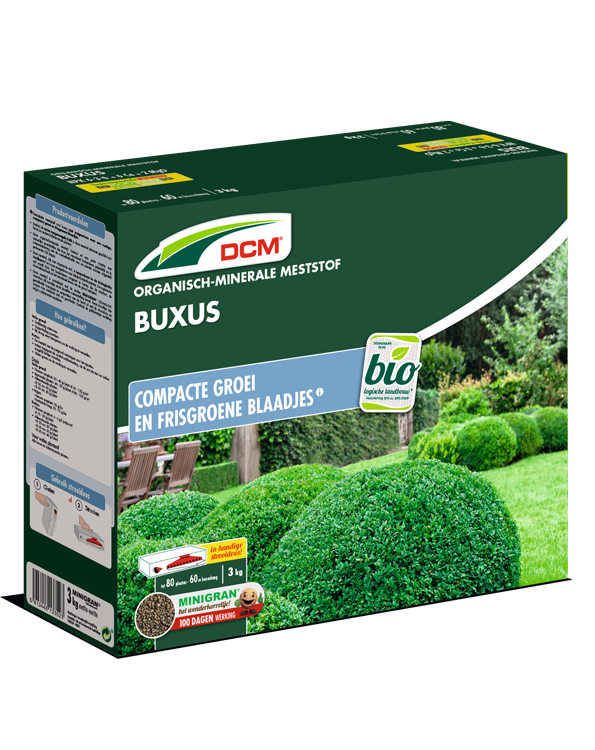 Groene verpakking van DCM Organische Meststof Buxus, 3 kg, met afbeelding van een buxushaag.