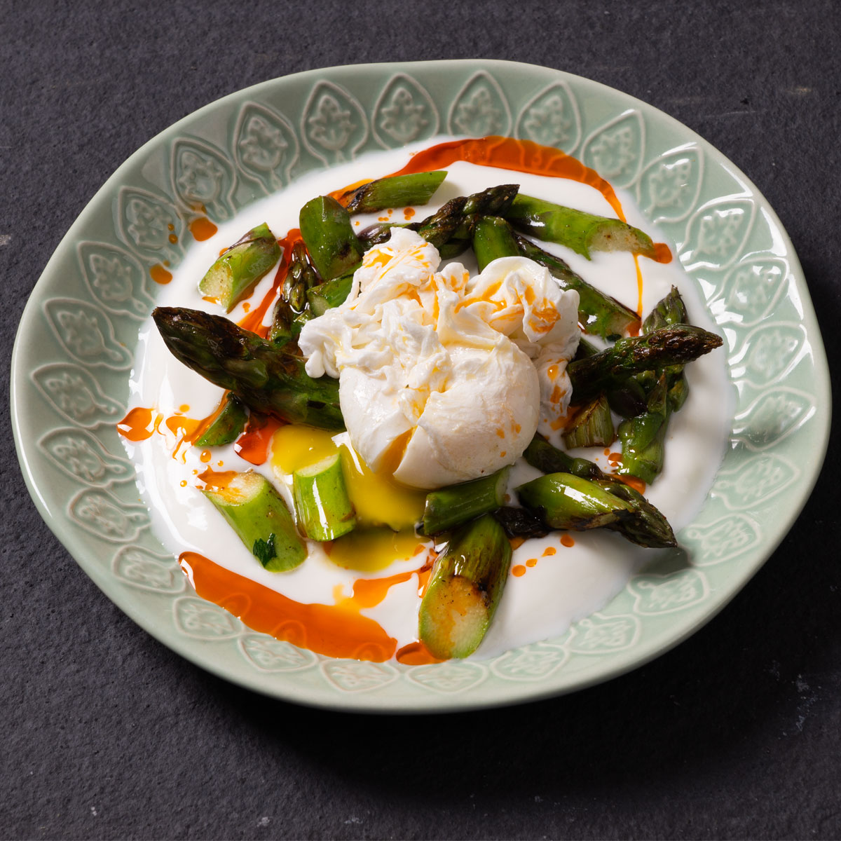 Türkisches Çılbır mit pochiertem Ei, Joghurt, grünem Spargel und Tomatenöl – frisch und lecker.