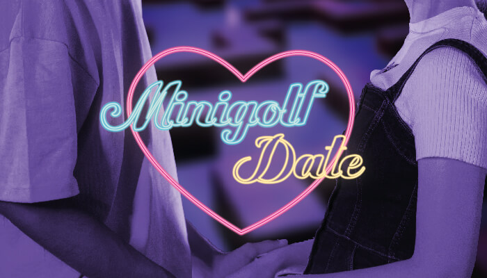 Nahaufnahme eines Paares in Freizeitkleidung mit einem leuchtenden Neonherz und den Worten "Minigolf Date" in Neonbuchstaben auf einem unscharfen blauen Hintergrund.