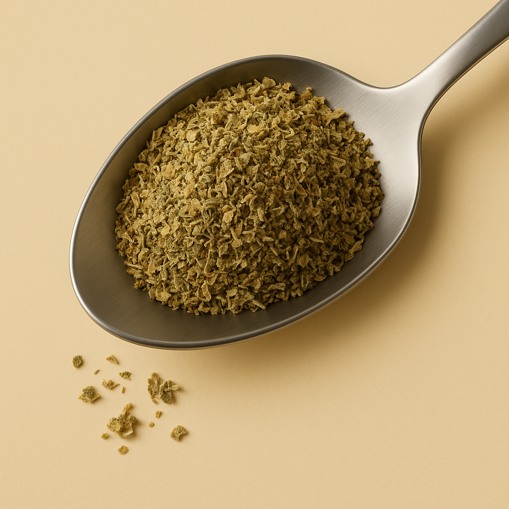 Spoon of dried Pizza Herbs on a beige background