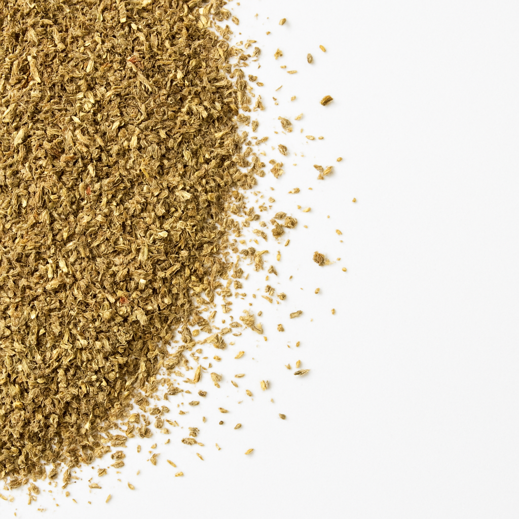 Close-up of ground dried Pizza Herbs scattered on a white background