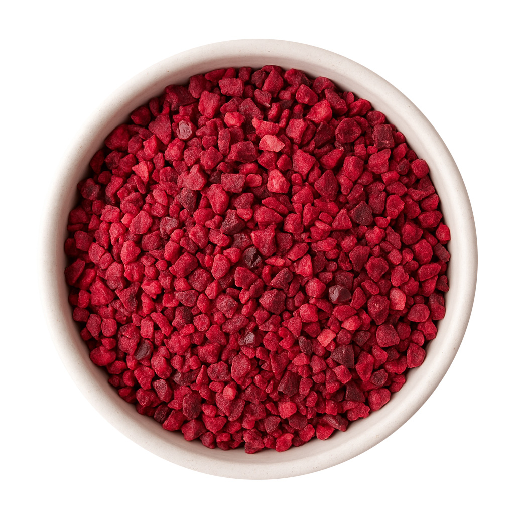 Top view of red fruit granules in white bowl
