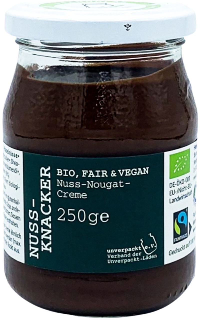 Glas mit Nuss-Knacker Bio Nuss-Nougat-Creme 250 g, dunkelbraune Creme, weißer Schraubdeckel, grünes Etikett mit Bio- und Fairtrade-Logo