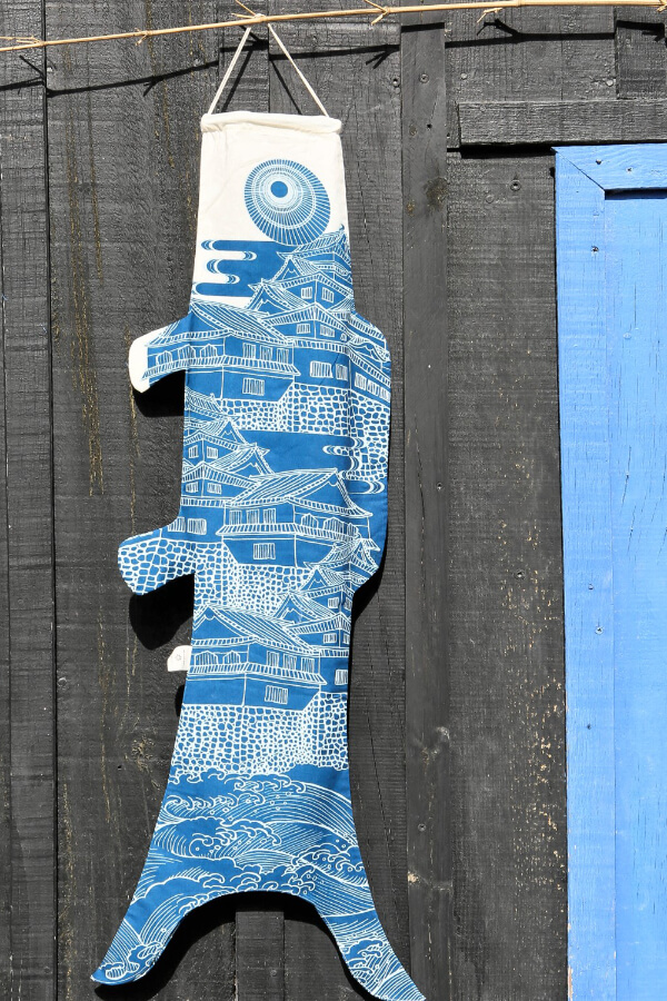 Koinobori Größe M Ôshiro in Blau hängt an einer braunen Holzwand