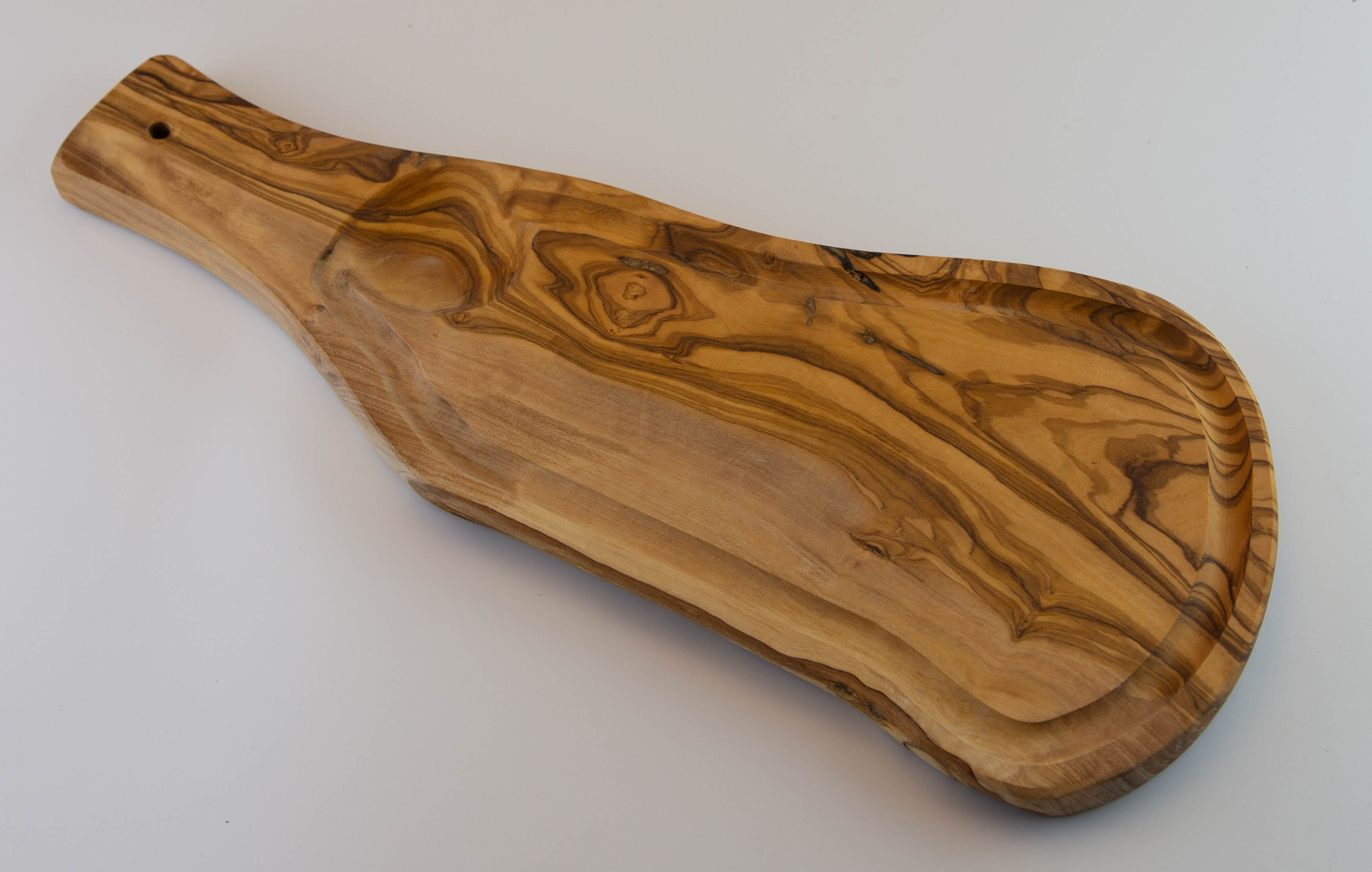 Rustic serving board with handle and juice groove.
