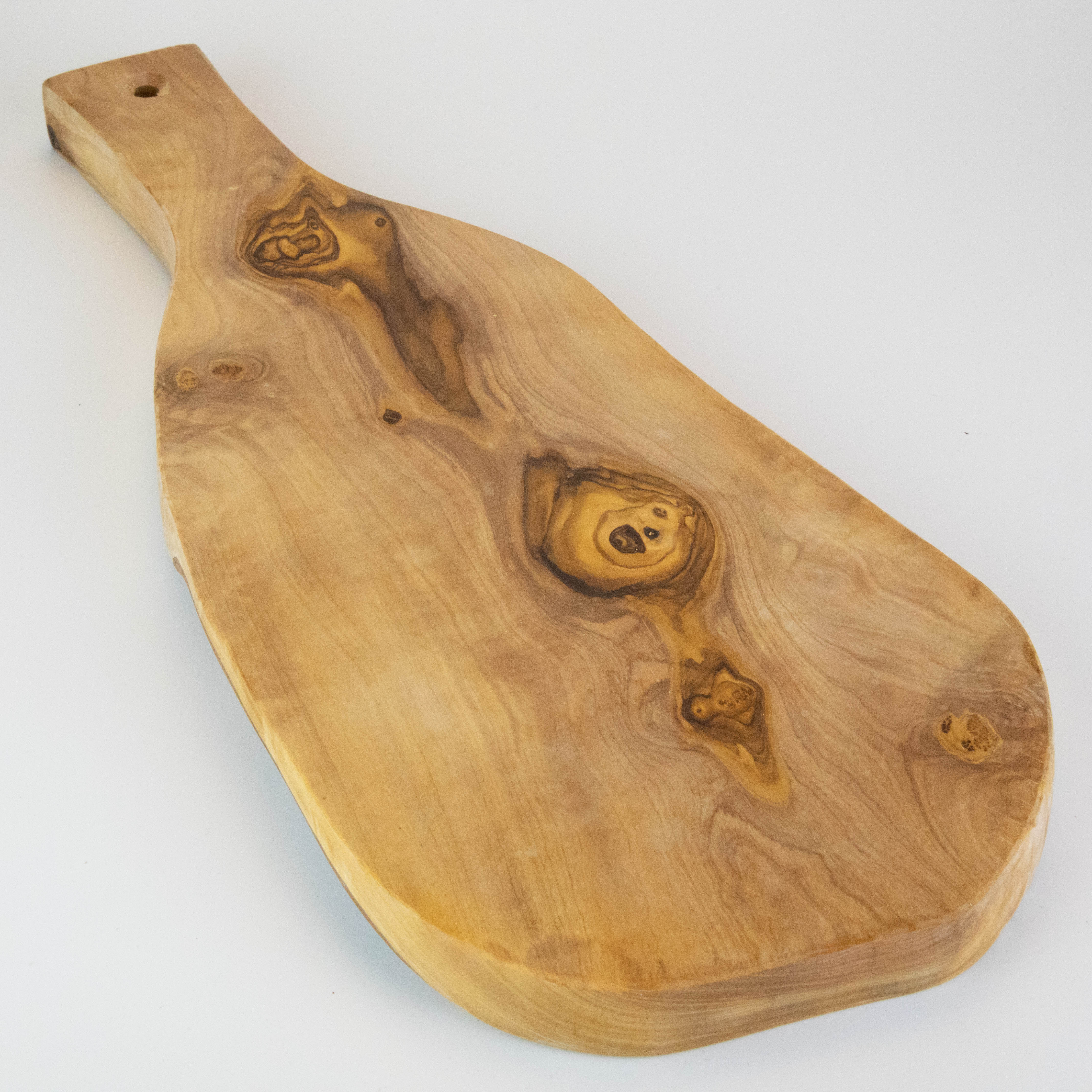 Rustic serving board with handle made of olive wood.
