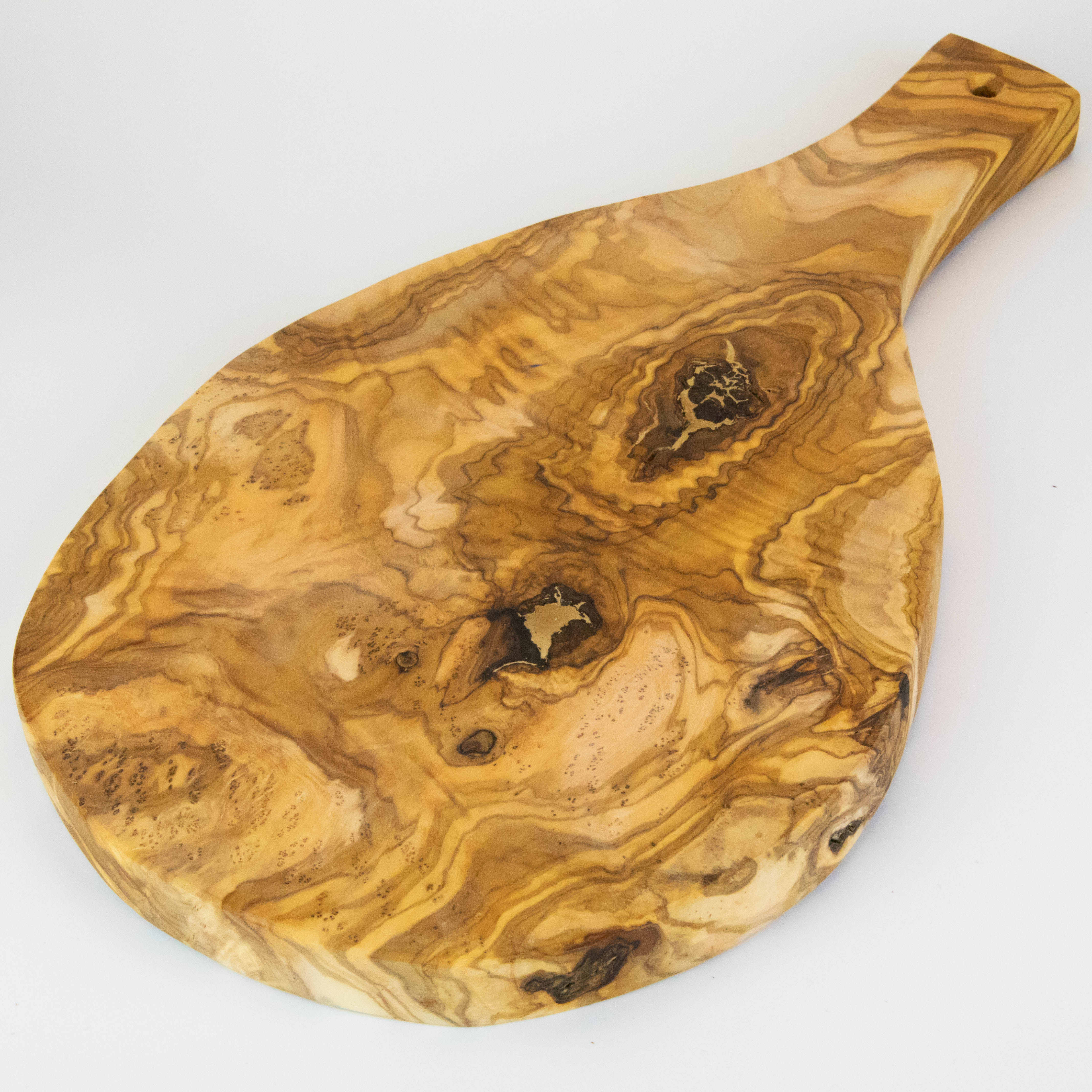 Rustic serving board with handle made of olive wood.