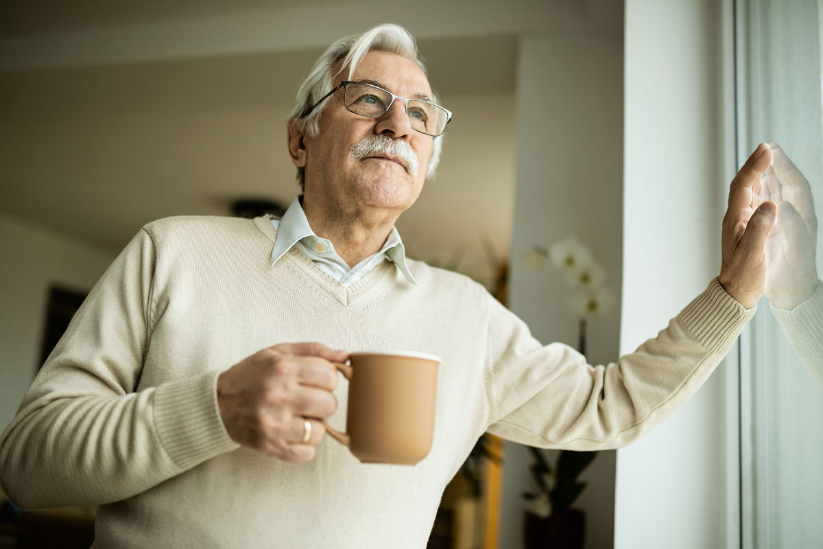 low-angle-view-senior-man-day-dreaming-while-drinking-coffee-looking-through-window low-angle-view-senior-man-day-dreaming-while-drinking-coffee-looking-through-window